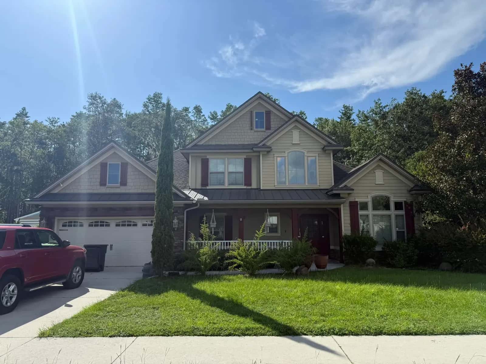 Completed gray architectural shingle roof on a two-story home