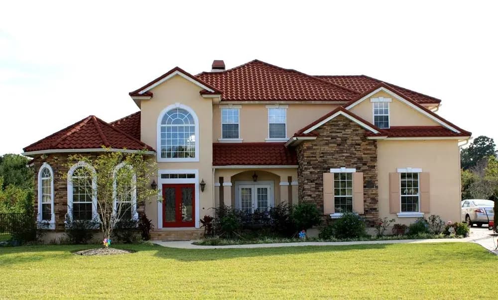 Stucco home with a completed red tile roof